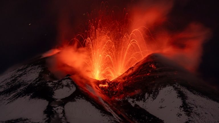 Lava erupts from snow-covered Mt Etna volcano, Sicily, Italy, early Saturday, Nov. 25, 2023. Europe&#39;s most active volcano remains active scattering ashes around a vastly populated area on its slopes. (AP Photo/Etnawalk, Giuseppe Di Stefano)