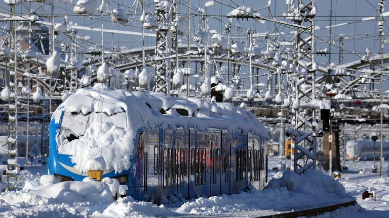 dpatop - 03 December 2023, Bavaria, Munich: A regional train covered in snow stands at the main station. Following the severe onset of winter in Bavaria, train services at the main station were still disrupted on Sunday morning. Photo by: Karl-Josef Hildenbrand/picture-alliance/dpa/AP Images