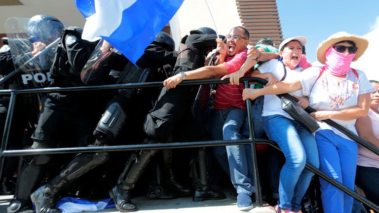 Riot police try to detain protesters during a march called "United for freedom" against Nicaraguan President Daniel Ortega in Managua, Nicaragua October 14, 2018. REUTERS/Oswaldo Rivas