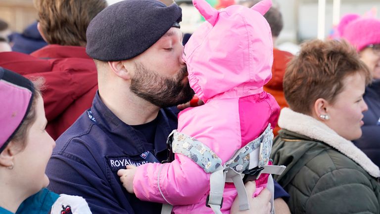 Petty Officer Nicholas Baker holds his daughter Amelia-Rose after the Royal Navy aircraft carrier HMS Prince of Wales returns to Portsmouth Naval Base following it&#39;s three-month deployment to the Eastern Seaboard of the United States, where the Prince of Wales has been undergoing trials and operating with aircraft and drones. Picture date: Monday December 11, 2023. PA Photo. See PA story DEFENCE Carrier. Photo credit should read: Andrew Matthews/PA Wire
