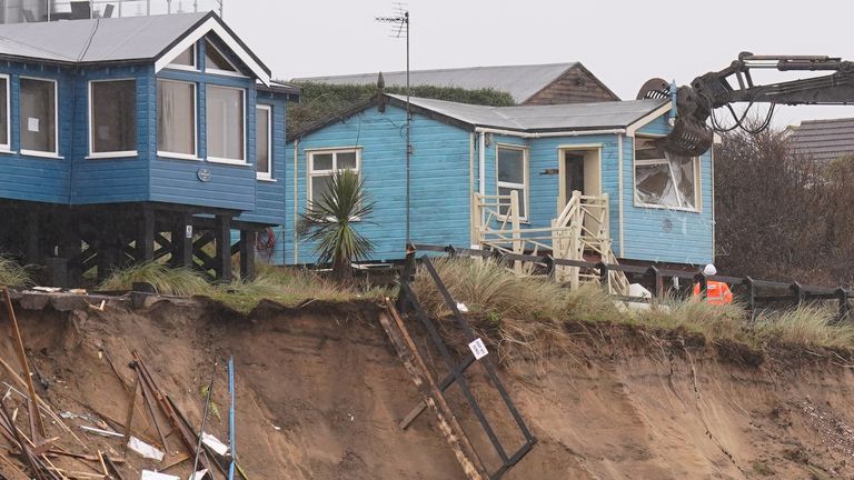 Demolition workers tear down the second of five clifftop homes in the village of Hemsby which has been hit by coastal erosion. High tides and strong winds caused the collapse of a stretch of private access road in Hemsby in Norfolk last month. Picture date: Saturday December 9, 2023.