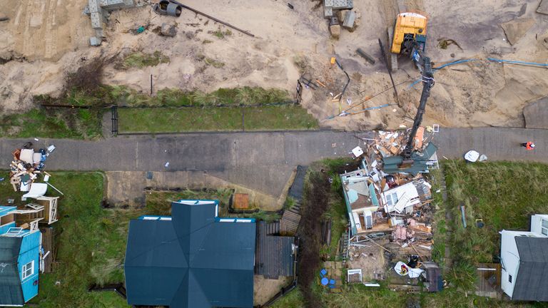 Demolition workers tear down the first of five clifftop homes in the village of Hemsby which has been hit by coastal erosion. High tides and strong winds caused the collapse of a stretch of private access road in Hemsby in Norfolk last month. Picture date: Saturday December 9, 2023.