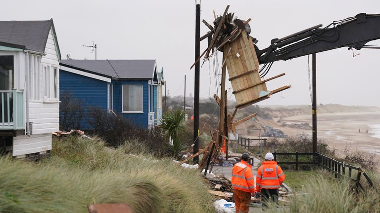 Demolition workers tear down the first of five clifftop homes in the village of Hemsby which has been hit by coastal erosion. High tides and strong winds caused the collapse of a stretch of private access road in Hemsby in Norfolk last month. Picture date: Saturday December 9, 2023. PA Photo. See PA story ENVIRONMENT Hemsby. Photo credit should read: Joe Giddens/PA Wire