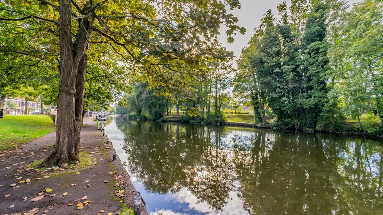 The tree line footpath along the River Wensum in the city of Norwich, Norfolk