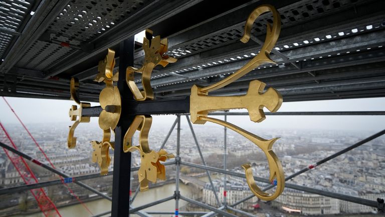 Part of the cross is seen at the top of the spire at Notre Dame de Paris cathedral Friday, Dec. 8, 2023 in Paris, France. French President Emmanuel Macron is visiting Notre Dame Cathedral on Friday, marking the one-year countdown to its reopening in 2024 following extensive restoration after the fire four years ago. Macron&#39;s visit, continuing his annual tradition since the blaze on April 15, 2019, is aimed to highlight the progress in the works, including the near completion of the cathedral spi