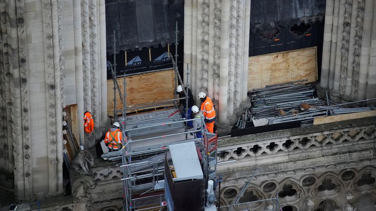 Workers operate at Notre Dame de Paris cathedral, Friday, Dec. 8, 2023 in Paris, France. French President Emmanuel Macron is visiting Notre Dame Cathedral on Friday, marking the one-year countdown to its reopening in 2024 following extensive restoration after the fire four years ago. Macron’s visit, continuing his annual tradition since the blaze on April 15 2019, is aimed to highlight the progress in the works, including the near completion of the cathedral spire. Christophe Ena/Pool via REUTER