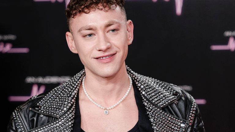 Olly Alexander poses for photographers as he arrives for a movie 