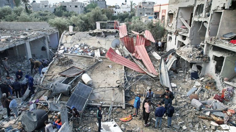Palestinians gather at the site of Israeli strikes on houses  at the Maghazi camp in the central Gaza