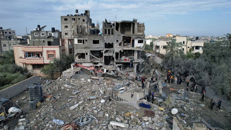 Palestinians gather at the site of Israeli strikes on houses at the Maghazi camp in the central Gaza 