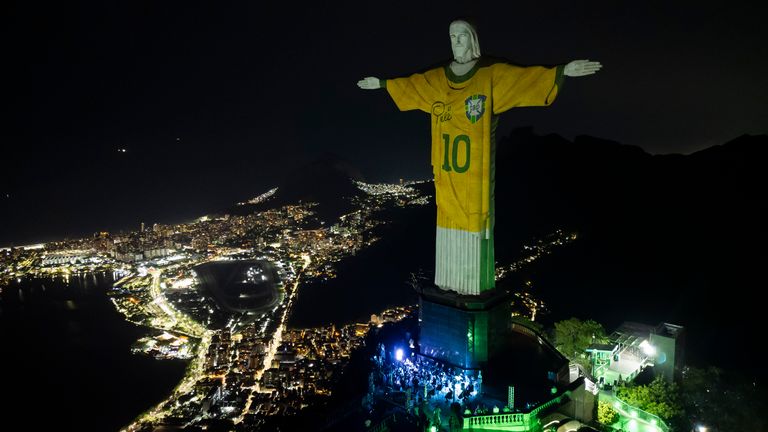 The Christ the Redeemer statue is illuminated with an image of Pele's Brazilian jersey. Pic: AP