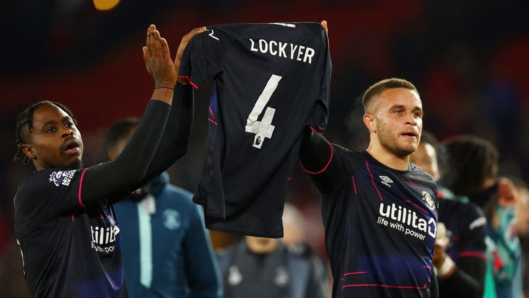 Luton Town&#39;s Pelly Ruddock Mpanzu and Carlton Morris hold a shirt in support of Luton Town&#39;s Tom Lockyer who is recovering following a cardiac arrest Pic: REUTERS/Molly Darlington