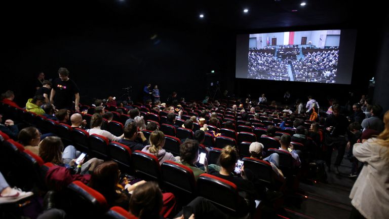 Poles gather in cinema for a screening of Polish Parliament session in Warsaw, Poland, December 11, 2023. REUTERS/Kuba Stezycki
