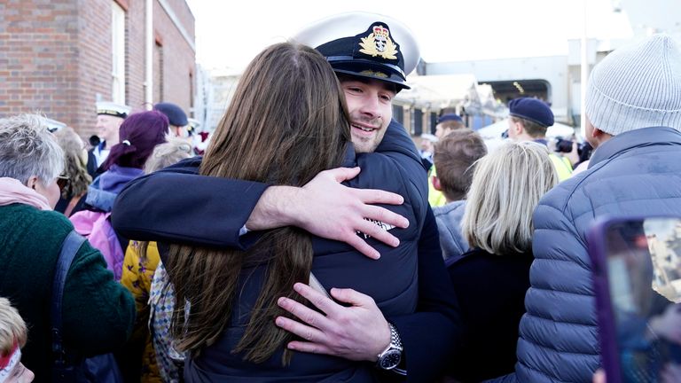 Midshipman Joshua Wood hugs his partner after the Royal Navy aircraft carrier HMS Prince of Wales returns to Portsmouth Naval Base following it&#39;s three-month deployment to the Eastern Seaboard of the United States, where the Prince of Wales has been undergoing trials and operating with aircraft and drones. Picture date: Monday December 11, 2023. PA Photo. See PA story DEFENCE Carrier. Photo credit should read: Andrew Matthews/PA Wire