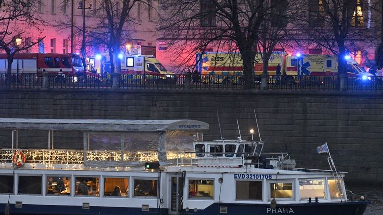 Ambulances and police at Ales Embankment, where shots were fired in the Faculty of Arts building (in background), in Prague, Czech Republic, on December 21, 2023. Pictured tourist boat on River Vltava. Photo/Vit Simanek (CTK via AP Images)