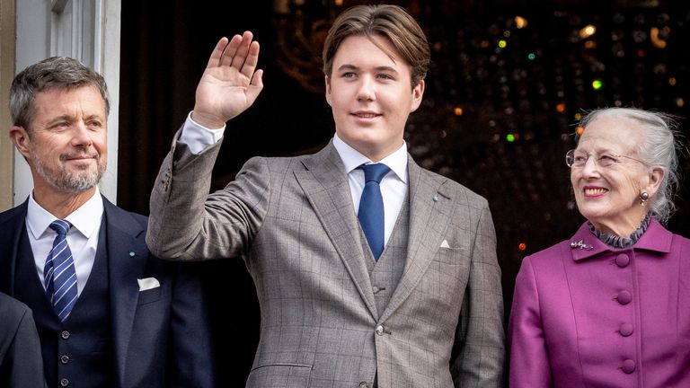 Crown Prince Frederik, Prince Christian and Queen Margrethe stand at the balcony of Frederik VIII's Palace as they celebrate Prince Christian's 18th birthday in October