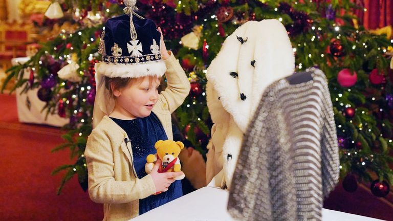 Seven-year-old Olivia Taylor from Sidcup wears a replica of the Queen Mary crown after taking tea with Queen Camilla at Windsor Castle 