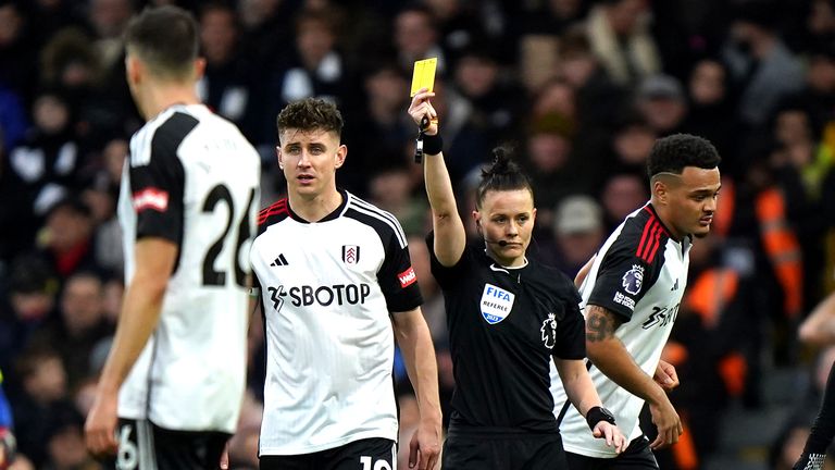 Referee Rebecca Welch (centre right) shows a yellow card to Fulham&#39;s Calvin Bassey (not pictured) for unsporting behaviour during the Premier League match at Craven Cottage, London. Picture date: Saturday December 23, 2023.