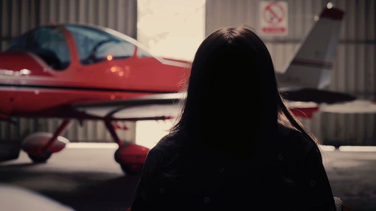 anonymous woman in front of Red Arrow plane