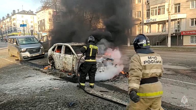 In this photo taken from video released by Russia Emergency Situations Ministry telegram channel on Saturday, Dec. 30, 2023, Firefighters extinguish burning cars after shelling in Belgorod, Russia. Pic: Russia Emergency Situations Ministry telegram channel via AP