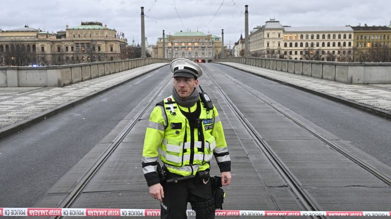 A police officer patrols the closed Manes Bridge heading towards Jan Palach Square, where shots were fired in the Faculty of Arts building, in Prague, Czech Republic
Pic:CTK/AP
