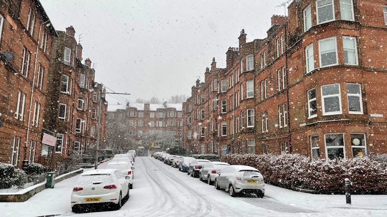 Snow falls covering the roads and footpaths in the Shawlands area of Glasgow 