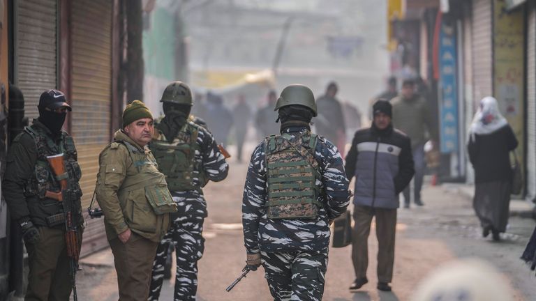 Indian paramilitary soldiers and policemen guard the main market in Srinagar, Indian controlled Kashmir