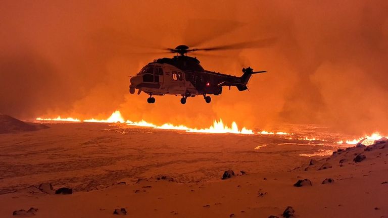 Helicopter flies over volcano in Iceland 