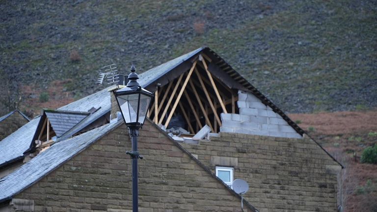 Part of a roof is torn away fron a house in Manchester by a &#39;tornado&#39;