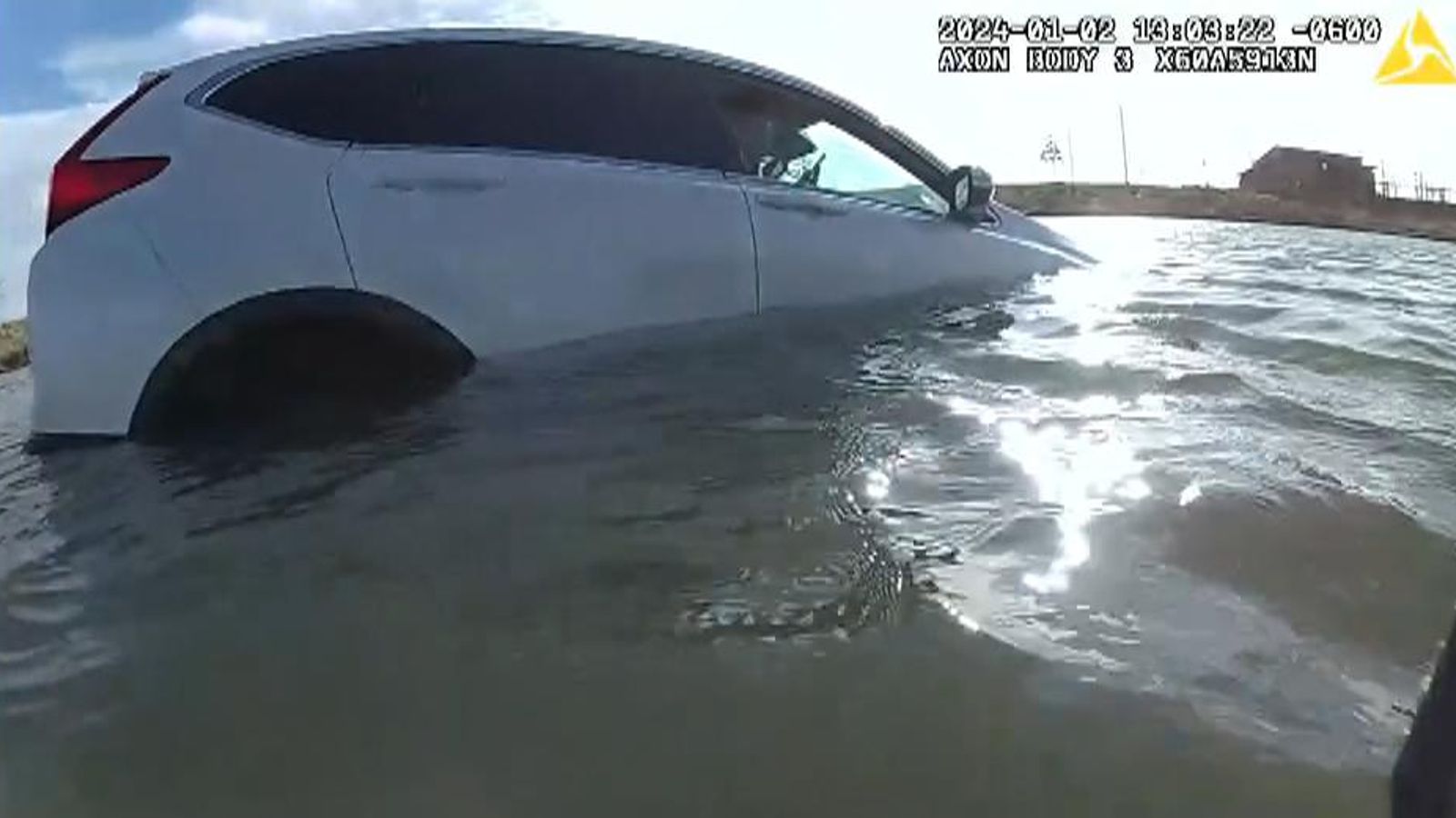 Police rescue family trapped in car that crashed into freezing pond ...