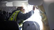 FILE PHOTO: National Transportation Safety Board (NTSB) Investigator-in-Charge John Lovell examines the fuselage plug area of Alaska Airlines Flight 1282 Boeing 737-9 MAX, which was forced to make an emergency landing with a gap in the fuselage, in Portland, Oregon, U.S. January 7, 2024. NTSB/Handout via REUTERS./File Photo