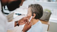 Doctor analysing human ear

