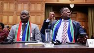 South Africa&#39;s Minister of Justice Ronald Lamola and South African Ambassador to the Netherlands Vusimuzi Madonsela sit inside the International Court of Justice (ICJ) as judges hear a request for emergency measures by South Africa to order Israel to stop its military actions in Gaza, in The Hague