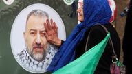 A woman touches a picture of deputy head of Hamas, Saleh al-Arouri, who was killed by what Lebanese and Palestinian security sources say was a drone strike by Israel, as mourners gather during his funeral in Beirut, Lebanon January 4, 2024. Israel has neither confirmed nor denied that it killed Arouri in the attack. REUTERS/Mohamed Azakir