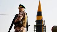 A Revolutionary Guard member stands guard in front of an Iranian domestically built missile displayed during Basij paramilitary force rally in support of the Palestinians in Tehran, Iran