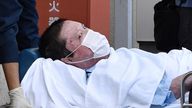 Shinji Aoba, a suspected arsonist who is suspected of killing 36 people at Kyoto Animation in July 2019, is seen on a stretcher as he is carried to Fushimi police station after being arrested in Kyoto, western Japan, in this photo taken by Kyodo May 27, 2020. Mandatory credit Kyodo/via REUTERS ATTENTION EDITORS - THIS IMAGE WAS PROVIDED BY A THIRD PARTY. IT WAS PROCESSED BY REUTERS TO ENHANCE QUALITY, AN UNPROCESSED VERSION HAS BEEN PROVIDED SEPARATELY MANDATORY CREDIT. JAPAN OUT. NO COMMERCIAL 