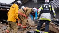 Firefighters and rescue workers search a collapsed house caused by powerful earthquake in Suzu, Ishikawa Prefecture Wednesday, Jan. 3, 2024. A series of powerful earthquakes hit western Japan, damaging buildings, vehicles and boats, with officials warning people in some areas on Tuesday to stay away from their homes because of a risk of more strong quakes. (AP Photo/Hiro Komae)