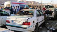 Pic: AP
People stay next to destroyed cars after an explosion in Kerman, Iran, Wednesday, Jan. 3, 2024. Iran says bomb blasts at an event honoring a prominent Iranian general slain in a U.S. airstrike in 2020 have killed at least 103 people and wounded 188 others. (Tasnim News Agency via AP)