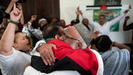 Pro-Palestinian supporters at the headquarters of the Palestinian mission in Pretoria, South Africa, react to the ICJ judgement. Pic: Reuters