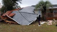A resident checks a collapsed roof after a line of storms roared through the area of Perdido Key near Pensacola, Florida, U.S. January 9, 2024. Tony Gilbertson/USA Today Network via REUTERS NO RESALES. NO ARCHIVES. MANDATORY CREDIT
