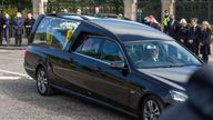 The hearse carrying the coffin of Queen Elizabeth II, draped with the Royal Standard of Scotland, passing through Aberdeen as it continues its journey to Edinburgh from Balmoral. Picture date: Sunday September 11, 2022.