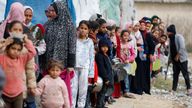 Women, girls and children wait for aid supplies in Rafah, southern Gaza