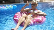 A stock image showing a man enjoying sunshine on holiday in a swimming pool. Picture downloaded from iStock by Ollie Cooper for story on Sunshine Saturday.