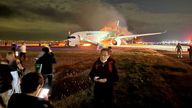 Passengers on the airport apron after escaping the plane Pic: William Manzione