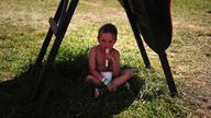 Anton Gatley, aged 4, from Devon in the shade during the hot weather at the Glastonbury Festival at Worthy Farm in Somerset. Picture date: Saturday June 24, 2023. PA Photo. See PA story SHOWBIZ Glastonbury. Photo credit should read: Ben Birchall/PA Wire