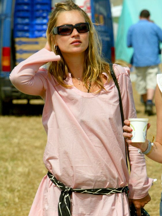 British supermodel Kate Moss walks through the Glastonbury Festival, Somerset, June 28, 2003. Around 150,000 people are expected to attend the three-day music event, famed for its mud, drugs, and mad antics. REUTERS/Toby Melville TM/MD
