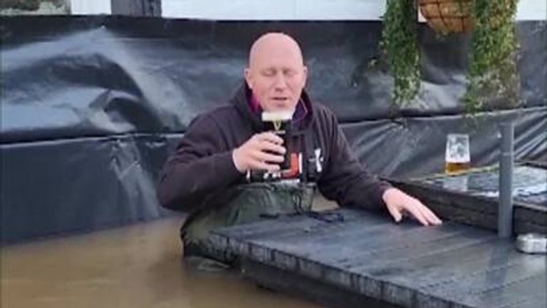 Owner of the Rose and Crown pub enjoys pint despite flooding