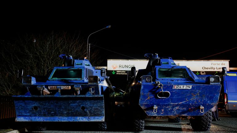 Armoured police vehicles are parked at the checkpoint near the International market as farmers are expected to protest in Rungis