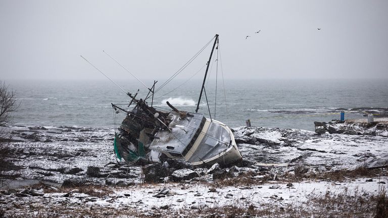 A fishing boat that had run aground at Trundy Beach on Saturday morning, Jan. 13, 2024, in Cape Elizabeth, Maine. A salvage business owner says the fishing trawler that wrecked off the Maine coast during a powerful storm, requiring a harrowing early-morning rescue, is a total loss. The Tara Lynn II crashed into the rocks early Saturday off Trundy Point, a few miles south of the Portland Head Light. (Derek Davis/Portland Press Herald via AP)