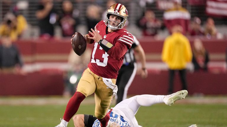 San Francisco 49ers quarterback Brock Purdy (13) runs against Detroit Lions linebacker Alex Anzalone during the second half of the NFC Championship NFL football game in Santa Clara, Calif., Sunday, Jan. 28, 2024. (AP Photo/Mark J. Terrill)