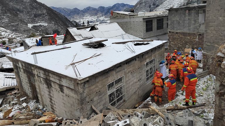 Rescue workers search the site of the landslide. Pic: Xinhua via AP